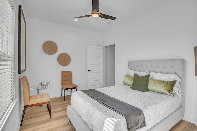 bedroom with ceiling fan and light hardwood / wood-style floors