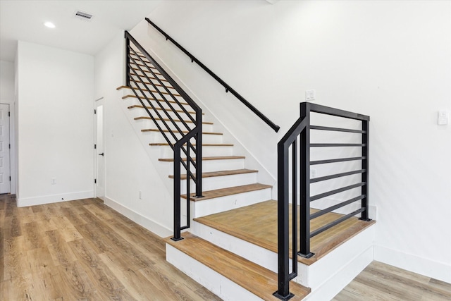 stairs with wood-type flooring