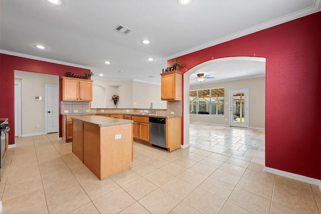 kitchen with sink, crown molding, stainless steel dishwasher, and a center island