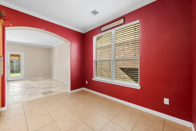 spare room featuring ornamental molding and light tile patterned floors