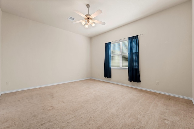 carpeted spare room with ceiling fan