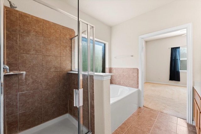 bathroom featuring vanity, plus walk in shower, and tile patterned flooring