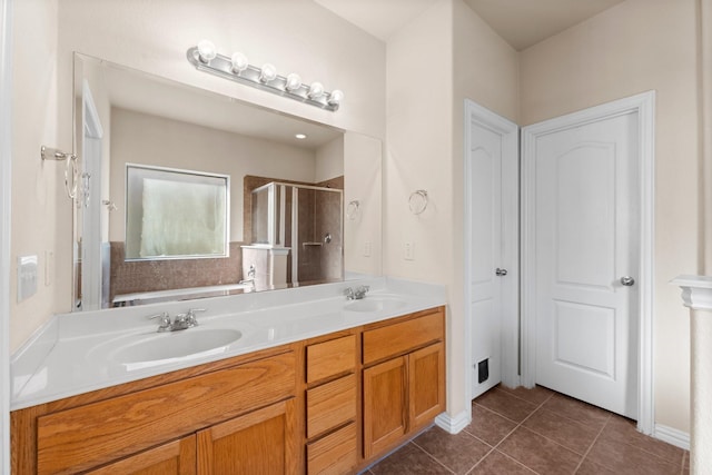 bathroom with an enclosed shower, vanity, and tile patterned floors