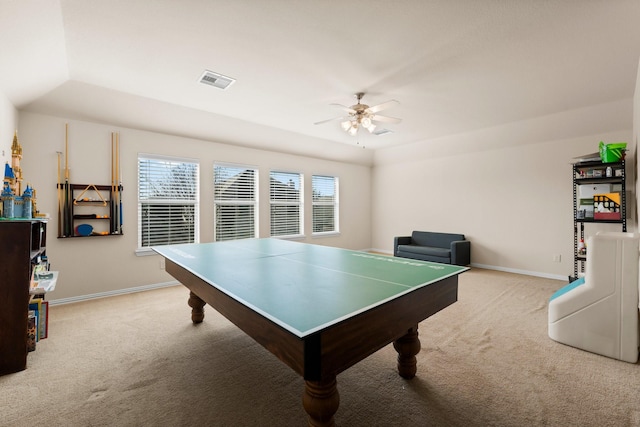 game room featuring light colored carpet, a raised ceiling, and a healthy amount of sunlight