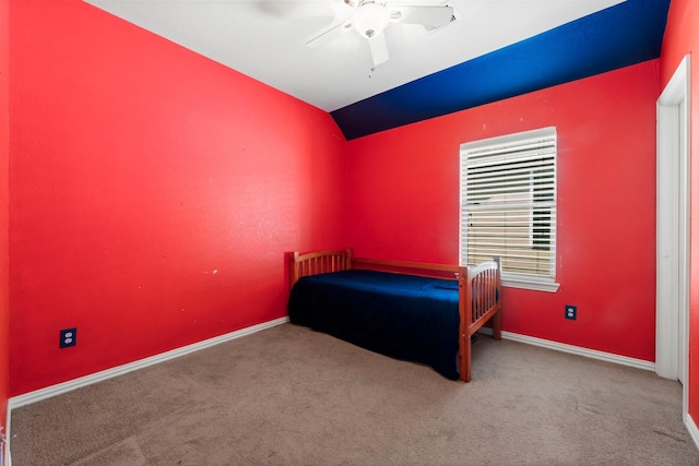 carpeted bedroom with ceiling fan and vaulted ceiling