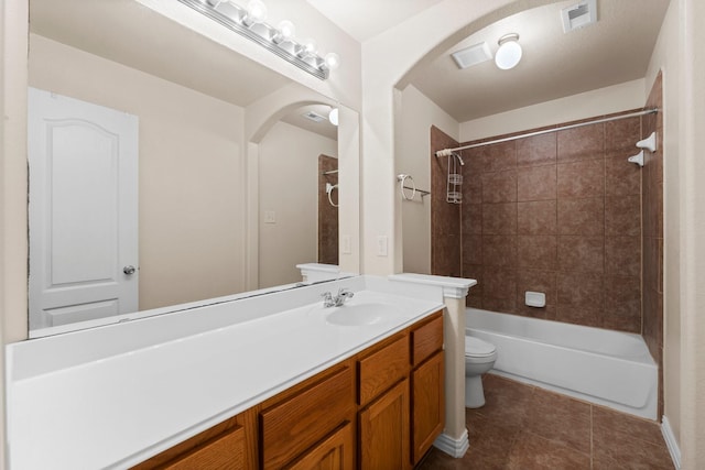 full bathroom featuring tile patterned floors, vanity, toilet, and tiled shower / bath