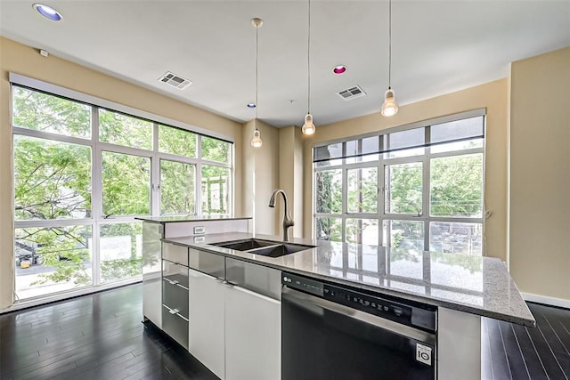 kitchen featuring sink, white cabinetry, light stone counters, decorative light fixtures, and black dishwasher