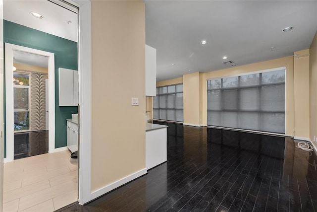 kitchen featuring white cabinetry and wood-type flooring