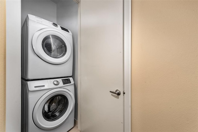 laundry area with stacked washer / dryer