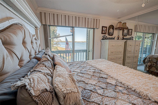 bedroom featuring ornamental molding, a water view, access to outside, and a textured ceiling