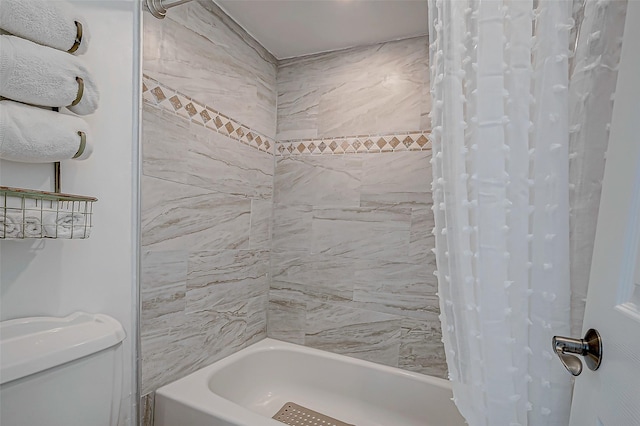 bathroom with shower / tub combo with curtain and toilet