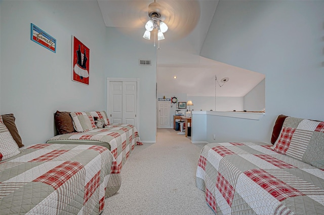 carpeted bedroom with a high ceiling, ceiling fan, and a closet