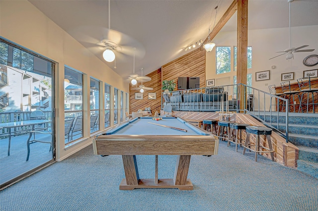 game room with carpet flooring, pool table, ceiling fan, and wood walls