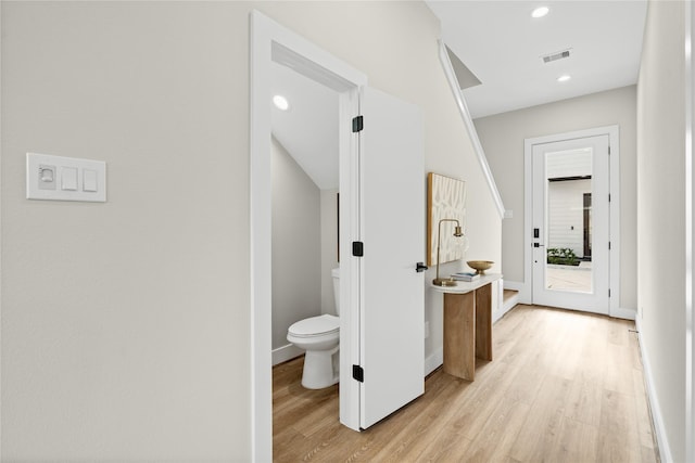 hallway with light hardwood / wood-style flooring