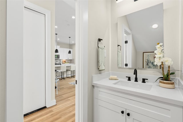 bathroom with vanity and hardwood / wood-style floors