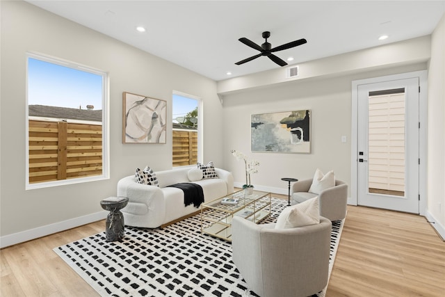 living room featuring light hardwood / wood-style floors and ceiling fan