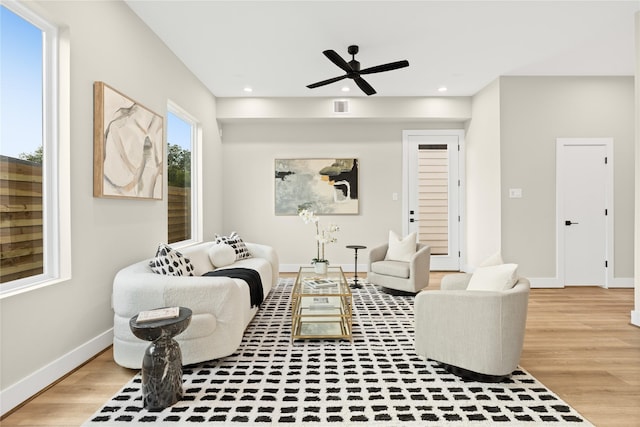 living room with wood-type flooring and ceiling fan