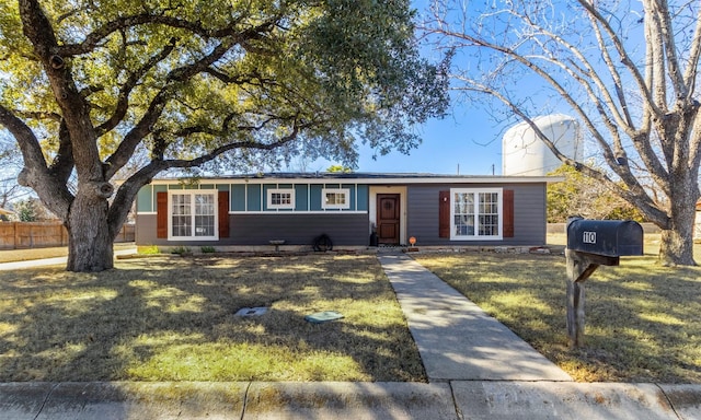 single story home featuring a front yard