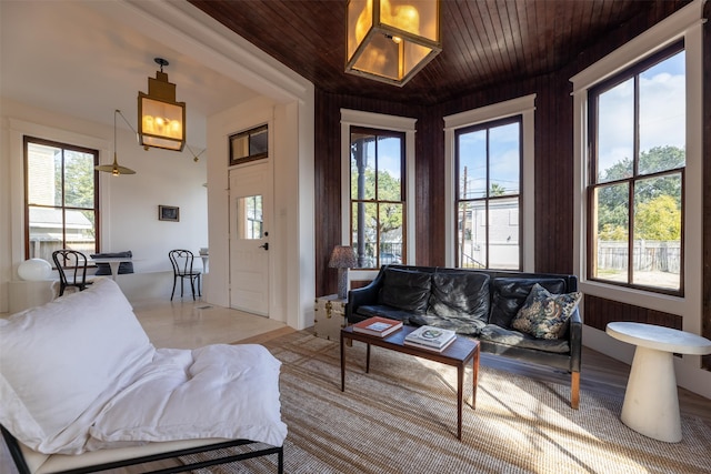 living room featuring wooden walls and wood ceiling