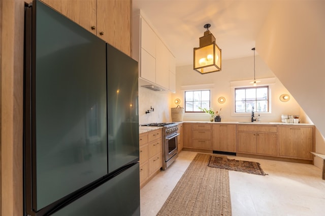 kitchen featuring pendant lighting, refrigerator, sink, high end stainless steel range, and light brown cabinets