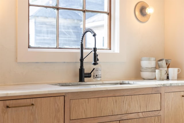 interior details featuring sink and light brown cabinets