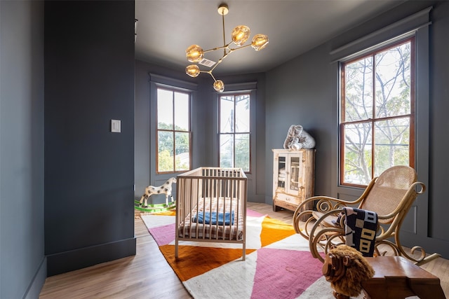 bedroom featuring light hardwood / wood-style flooring and a chandelier