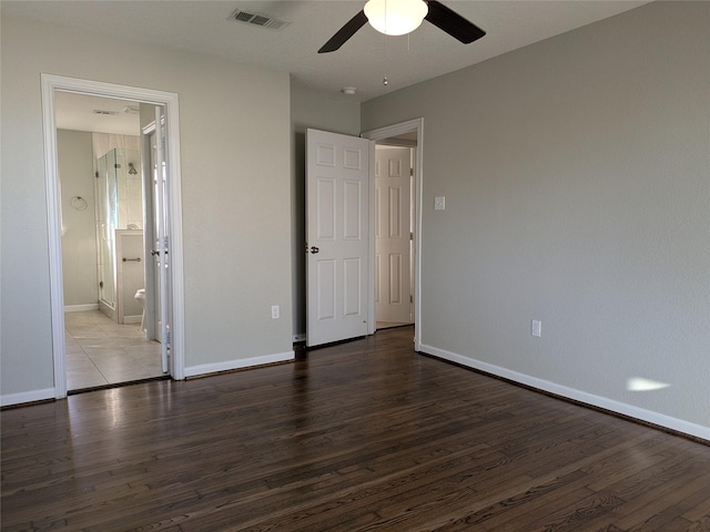 unfurnished bedroom featuring dark hardwood / wood-style floors, connected bathroom, and ceiling fan