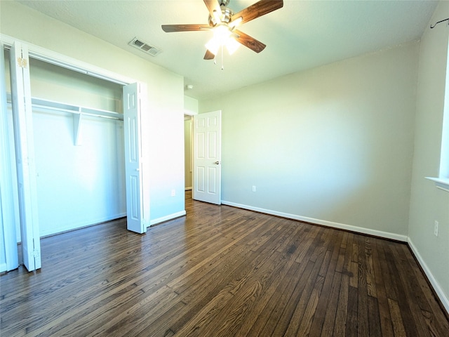 unfurnished bedroom featuring ceiling fan, dark hardwood / wood-style floors, and a closet