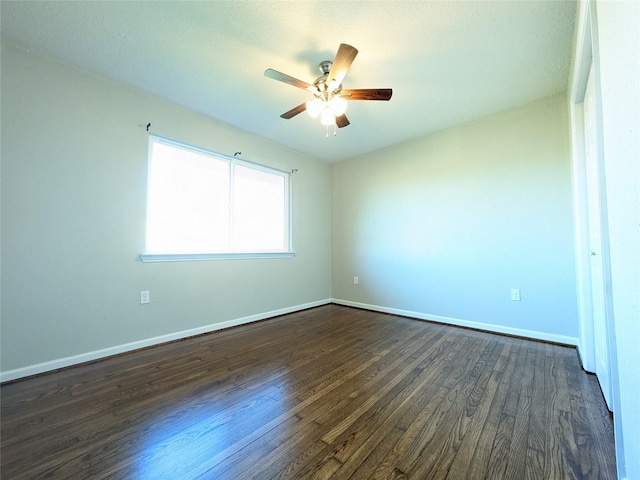 unfurnished room with dark hardwood / wood-style floors and ceiling fan