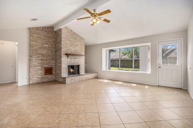 unfurnished living room featuring light tile patterned floors, lofted ceiling with beams, a textured ceiling, and a brick fireplace