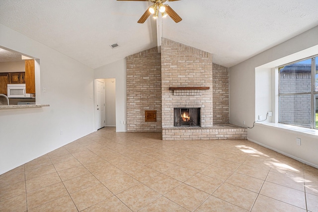 unfurnished living room featuring light tile patterned floors, a fireplace, vaulted ceiling with beams, and a textured ceiling