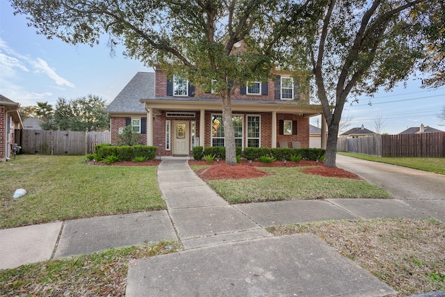 view of front of property featuring a front lawn and a porch