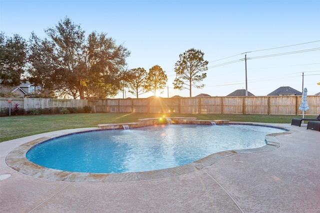 view of swimming pool with pool water feature, a patio, and a lawn