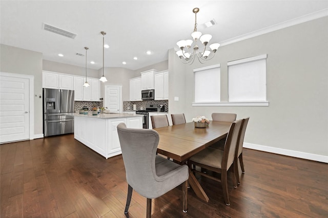 dining room featuring dark hardwood / wood-style flooring, sink, and a notable chandelier