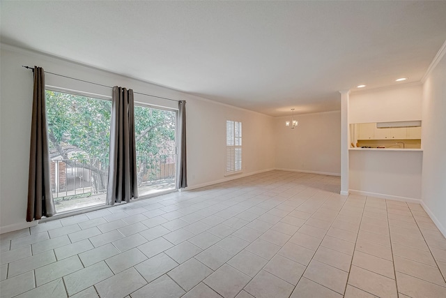 spare room featuring a notable chandelier, crown molding, and light tile patterned flooring