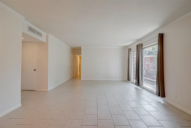 tiled spare room featuring crown molding