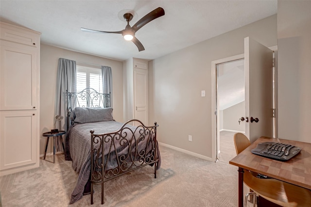 bedroom with light carpet, a ceiling fan, and baseboards