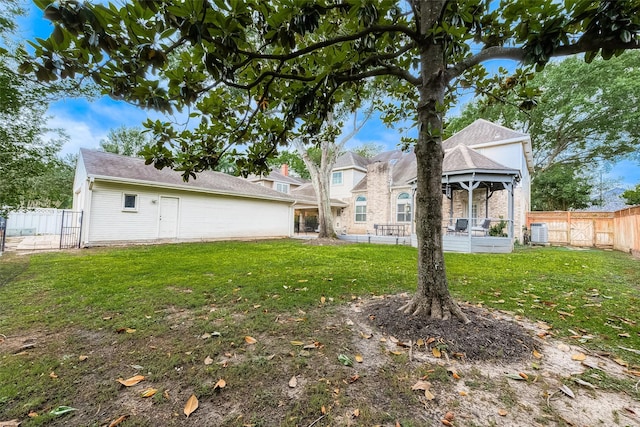 back of property with a yard, central AC unit, a gazebo, and a fenced backyard