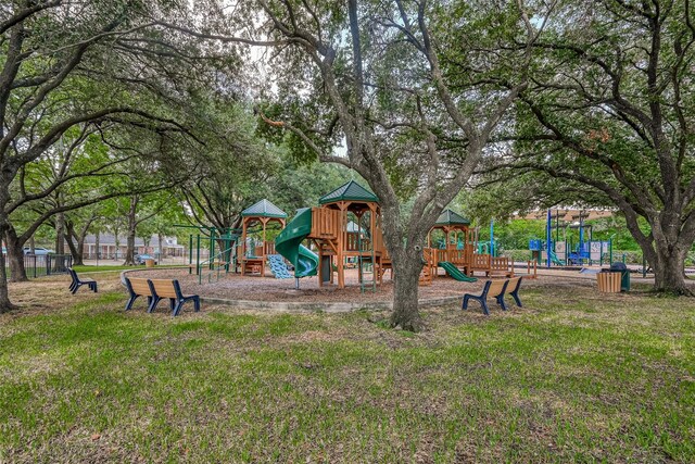 view of jungle gym featuring a lawn