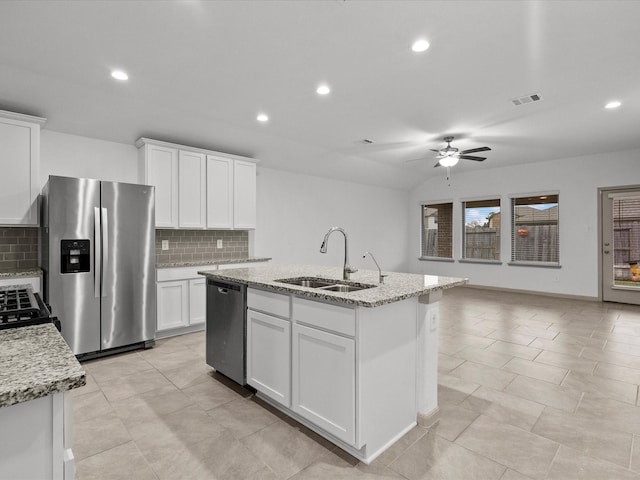 kitchen featuring sink, white cabinets, decorative backsplash, a kitchen island with sink, and stainless steel appliances