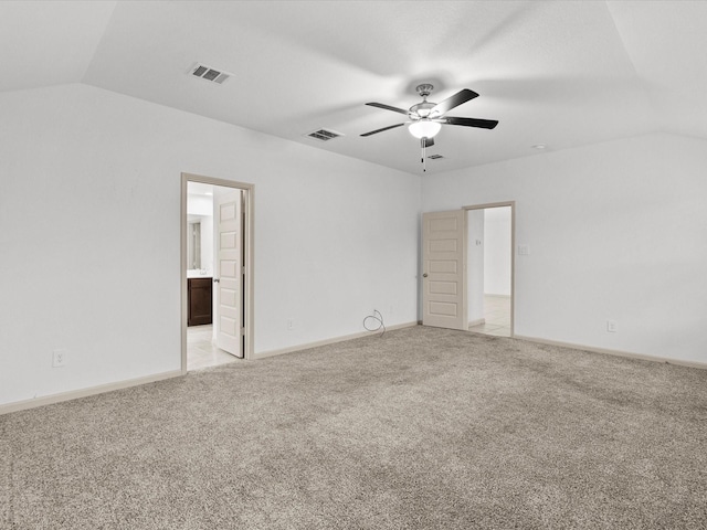 empty room with lofted ceiling, light carpet, and ceiling fan