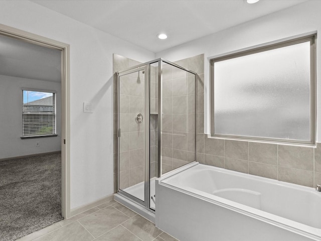 bathroom featuring tile patterned floors and independent shower and bath