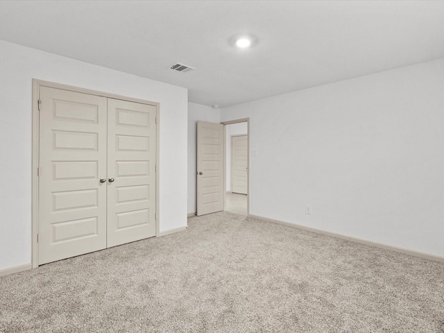 unfurnished bedroom featuring carpet and a closet