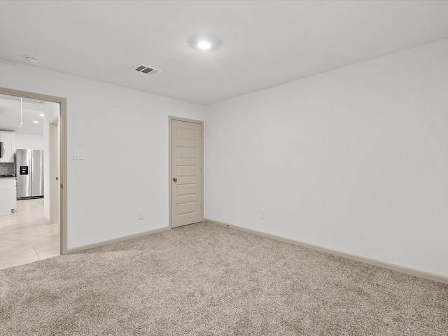 empty room featuring light colored carpet