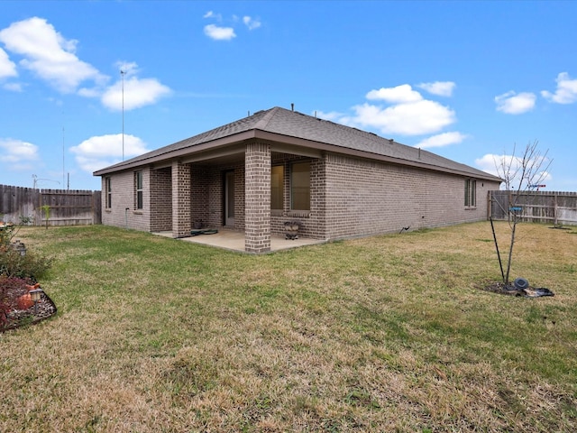 back of property featuring a yard and a patio