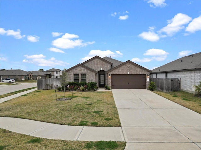 view of front of property featuring a garage and a front lawn