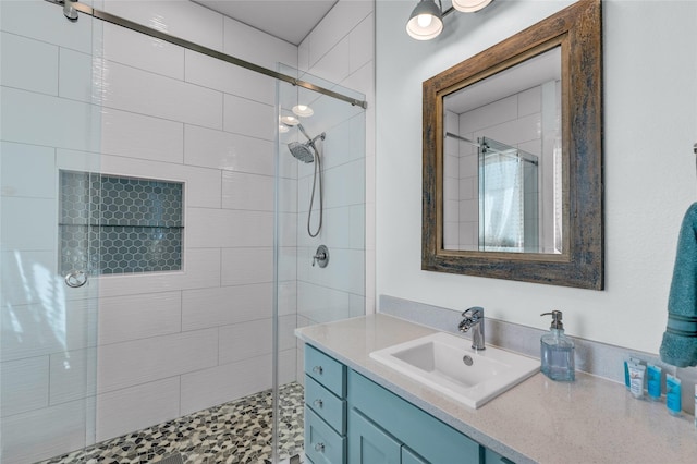 bathroom featuring walk in shower and vanity