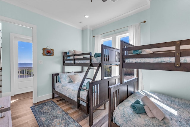 bedroom featuring ornamental molding and light hardwood / wood-style floors