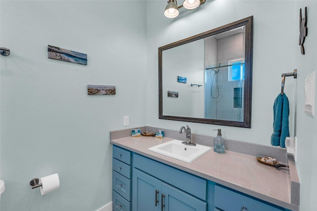 bathroom featuring vanity and tiled shower