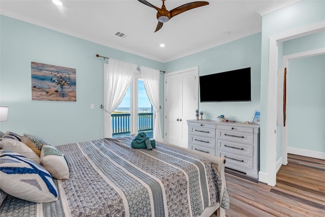 bedroom featuring ceiling fan, light hardwood / wood-style flooring, and access to outside